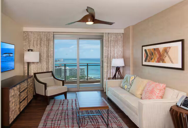 Bright coastal living room with private balcony and stunning ocean views