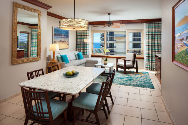 Bright coastal living space with dining area and partial ocean views
