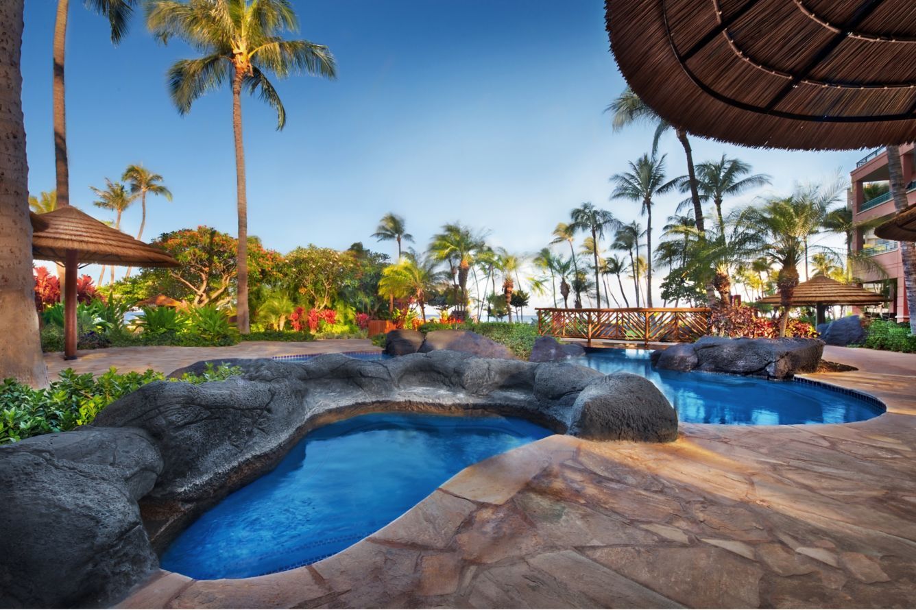 Tropical lagoon-style spa pools with lush gardens and ocean views