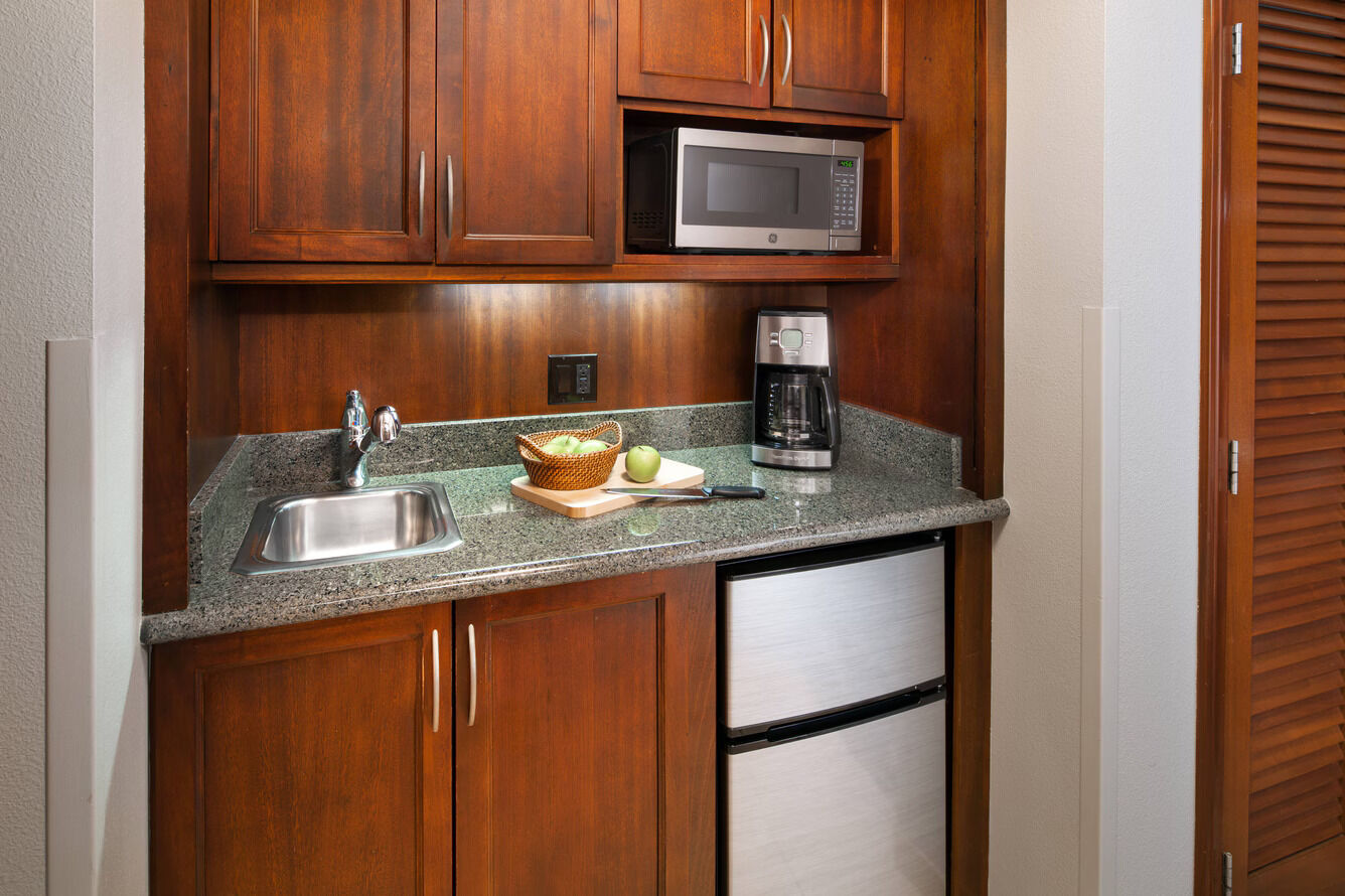 Convenient kitchenette with mini fridge, microwave, coffee maker, and sink