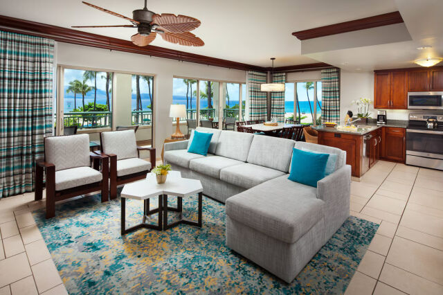 Bright oceanview living space with open kitchen and tropical resort vibes