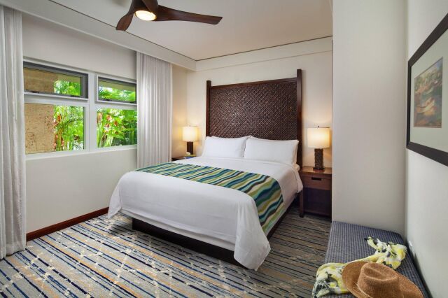 Bright tropical bedroom with garden views, cozy lighting, and stylish finishes