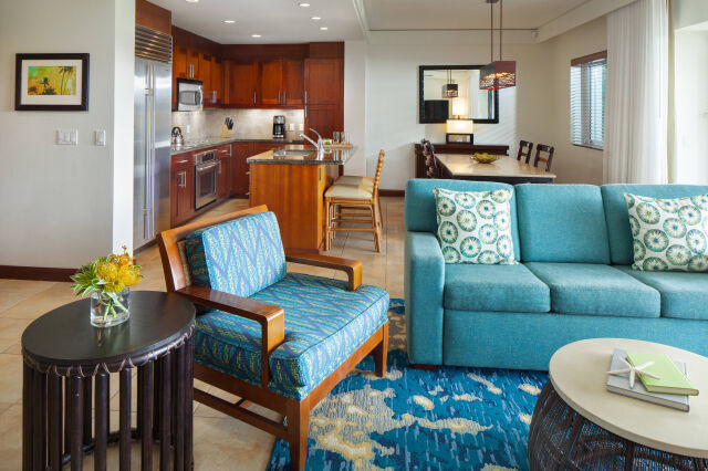 Bright open-concept living space with full kitchen and coastal-style seating