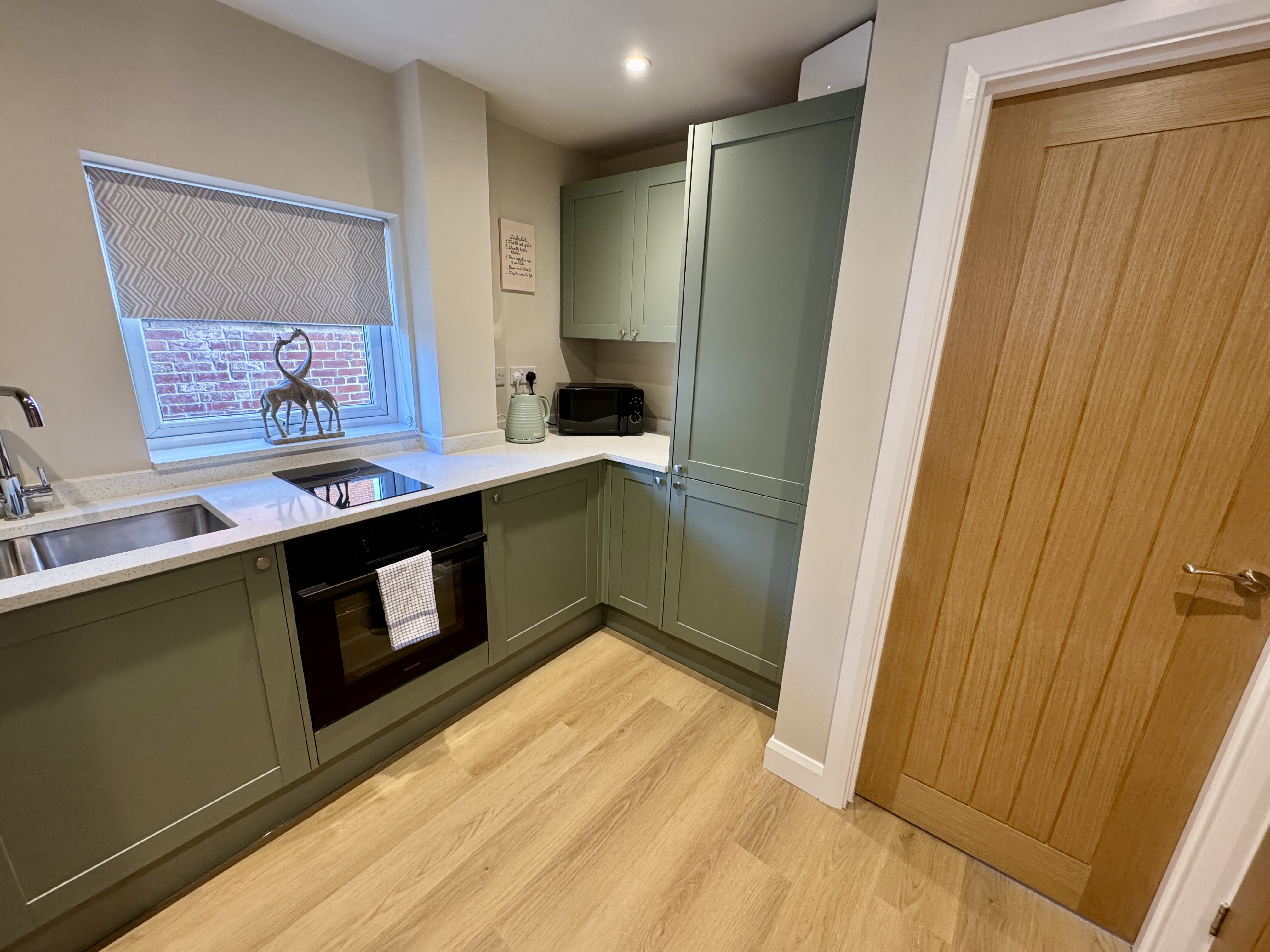 Modern sage-green kitchen with sleek finishes and great storage