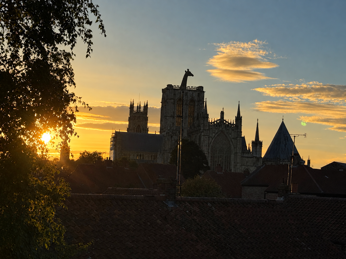Golden sunset over historic rooftops and cathedral skyline