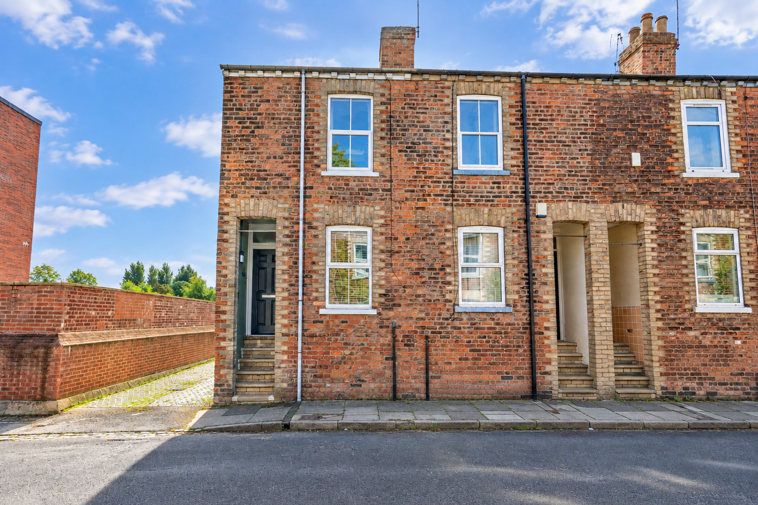 Charming brick townhouse with classic character and inviting curb appeal