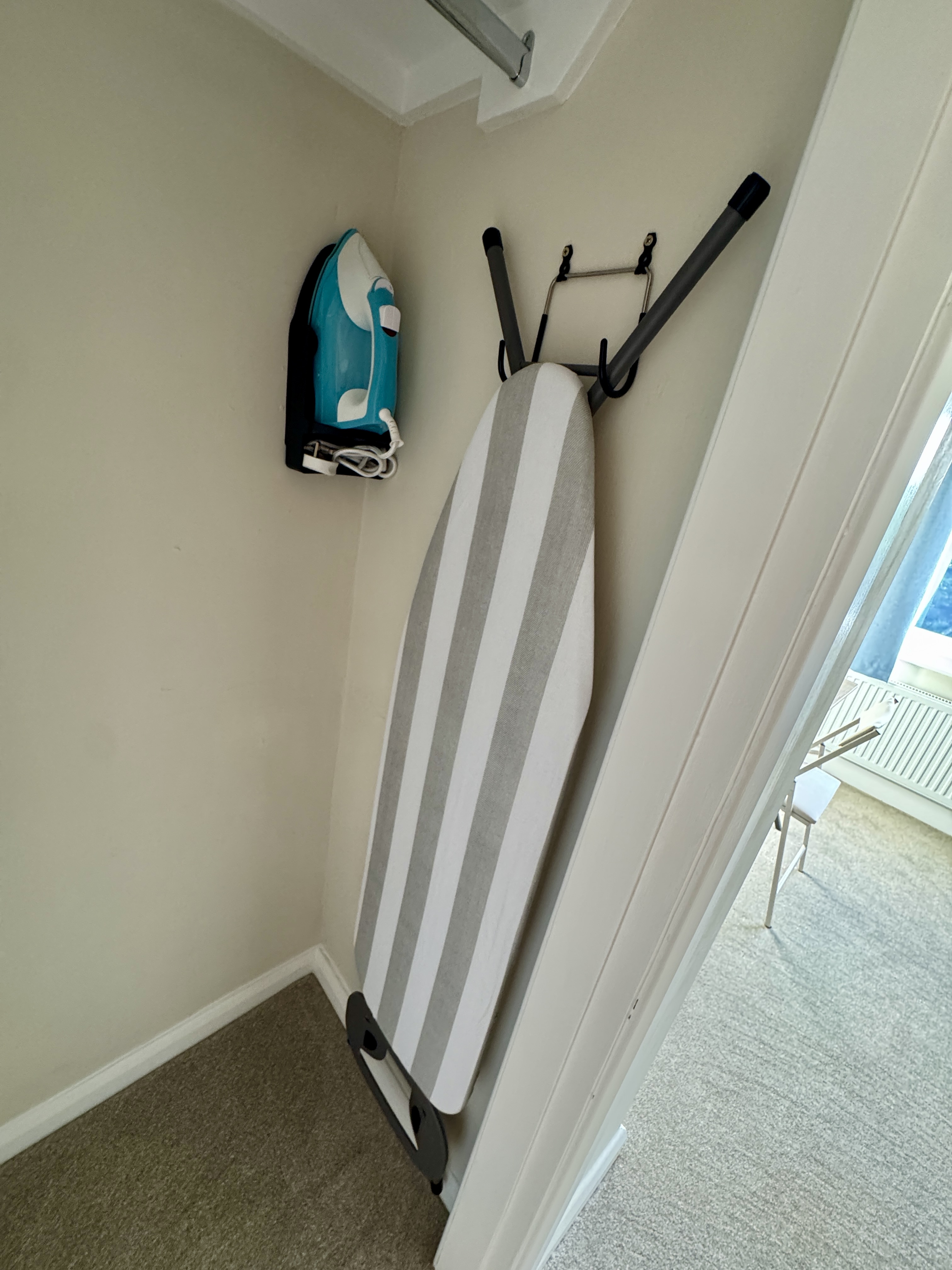 Handy ironing station with neatly tucked-away guest essentials