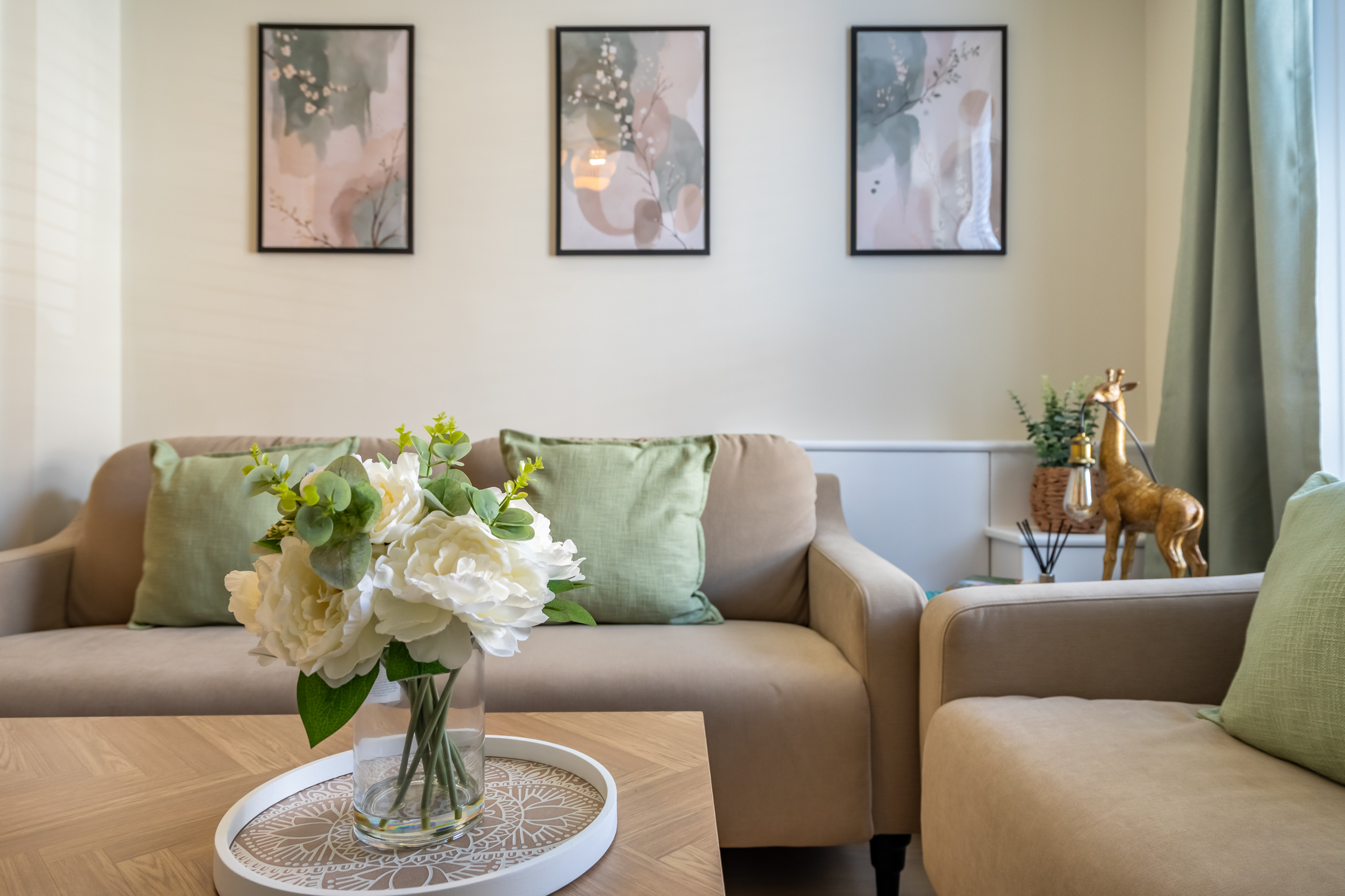 Stylish, cozy lounge with soft tones, floral accents, and elegant decor