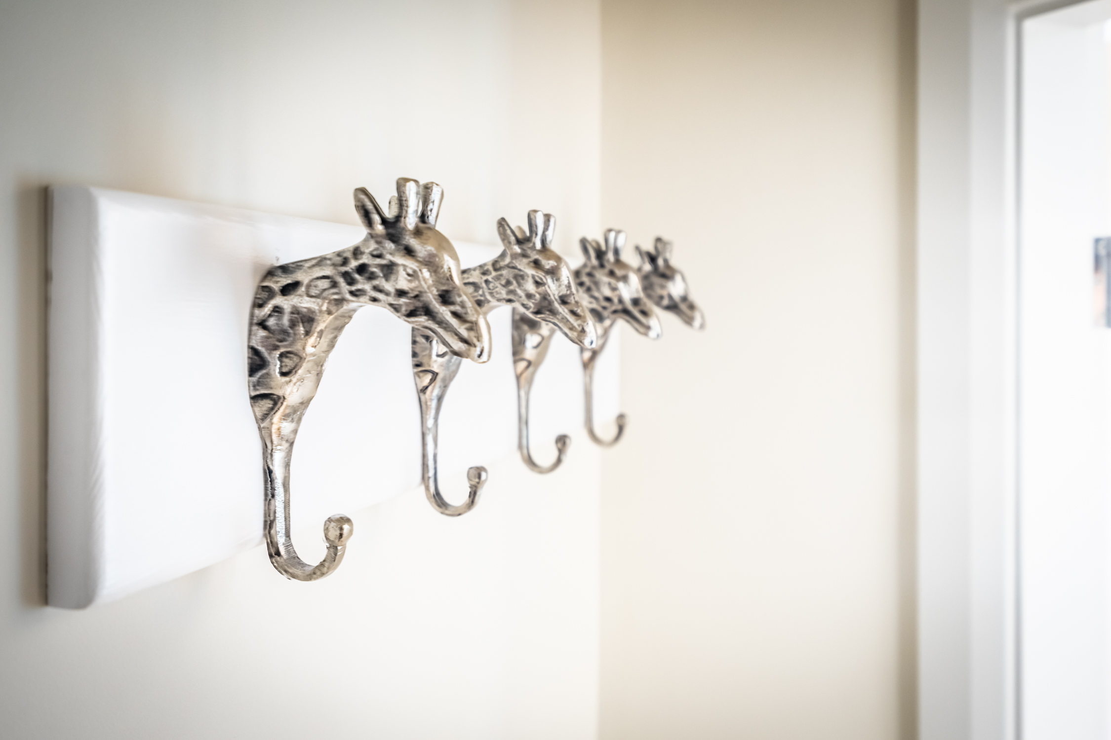 Whimsical giraffe hook rack adds charm and functional entryway storage