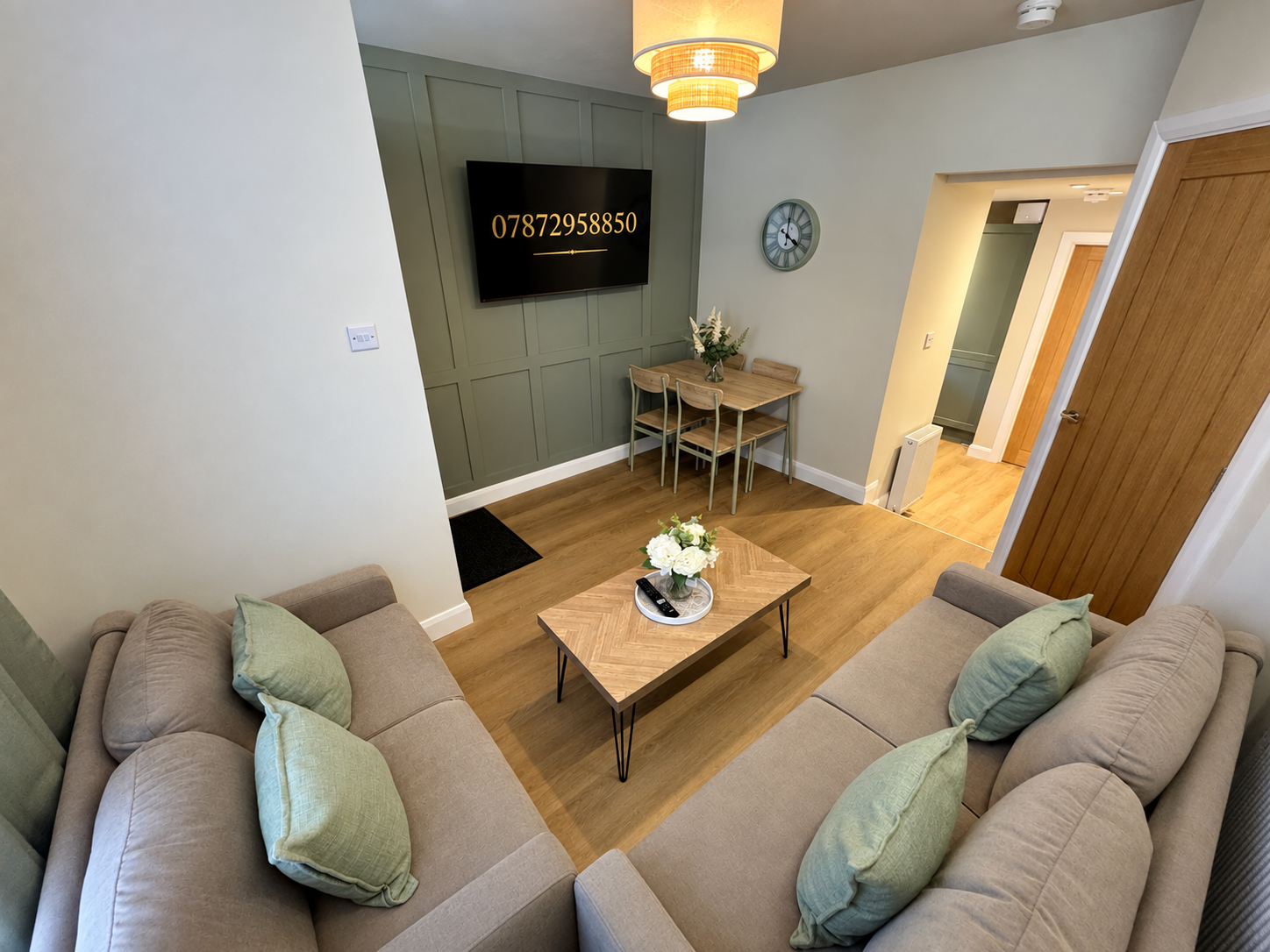 Cozy modern lounge with twin sofas, TV, and handy dining nook
