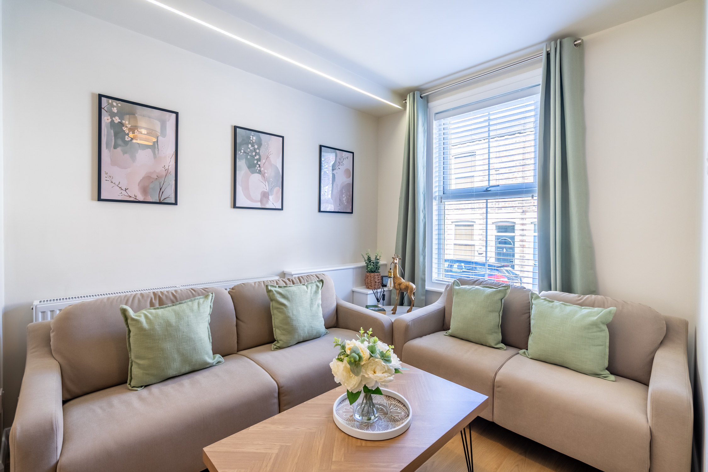 Bright, cozy lounge with stylish sofas, natural light, and modern decor