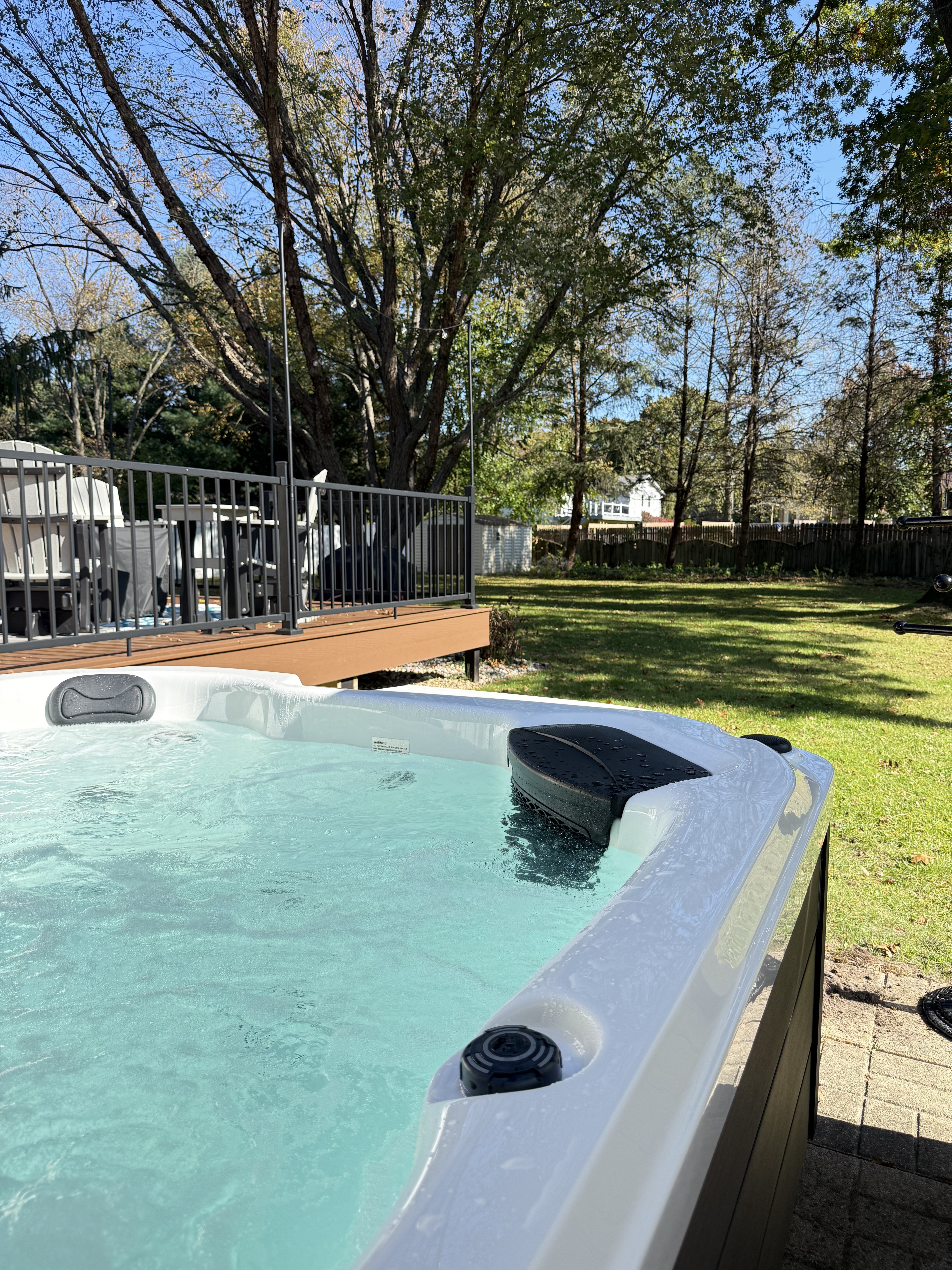 Relax in the private hot tub with serene yard views and mature trees