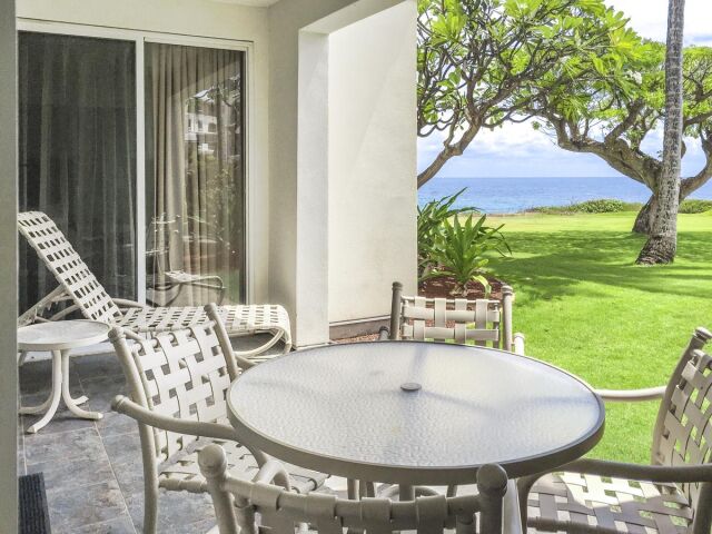 Private oceanview patio with tropical lawn and relaxing outdoor seating