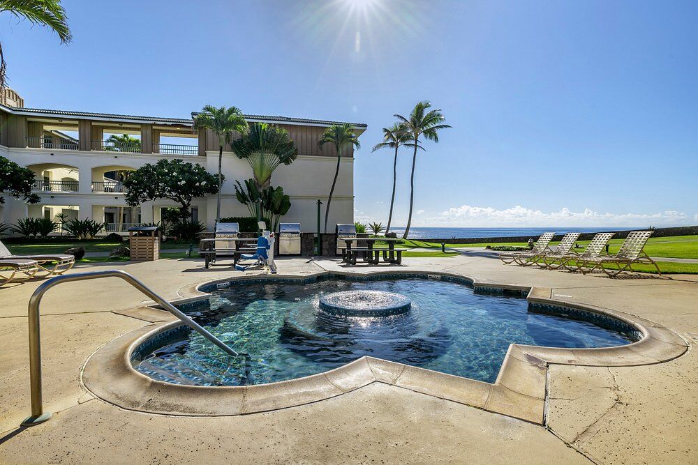 Oceanfront spa and pool deck with palm trees and relaxing resort vibes