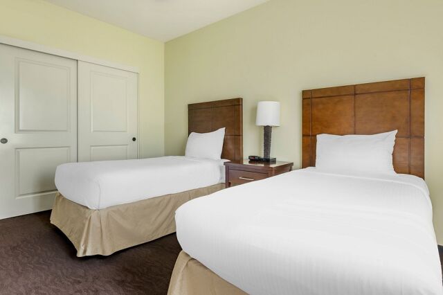 Bright double bedroom with two comfy beds and ample closet storage