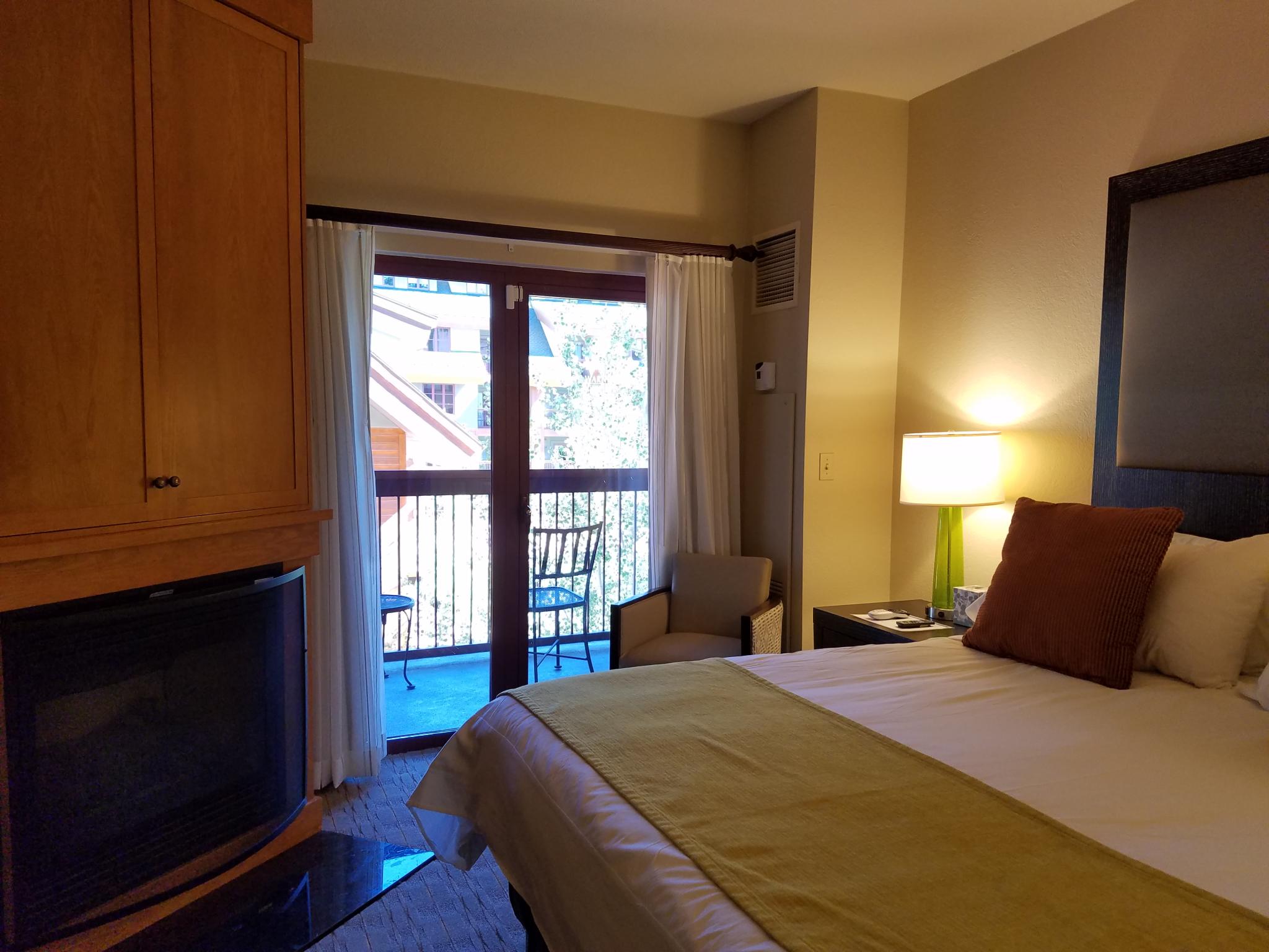 Cozy bedroom with fireplace and private balcony seating