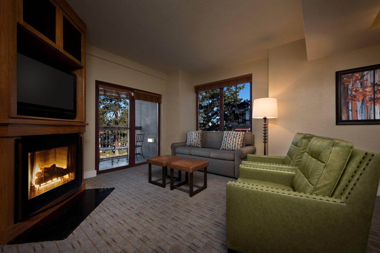 Cozy living room with fireplace, TV, and balcony views