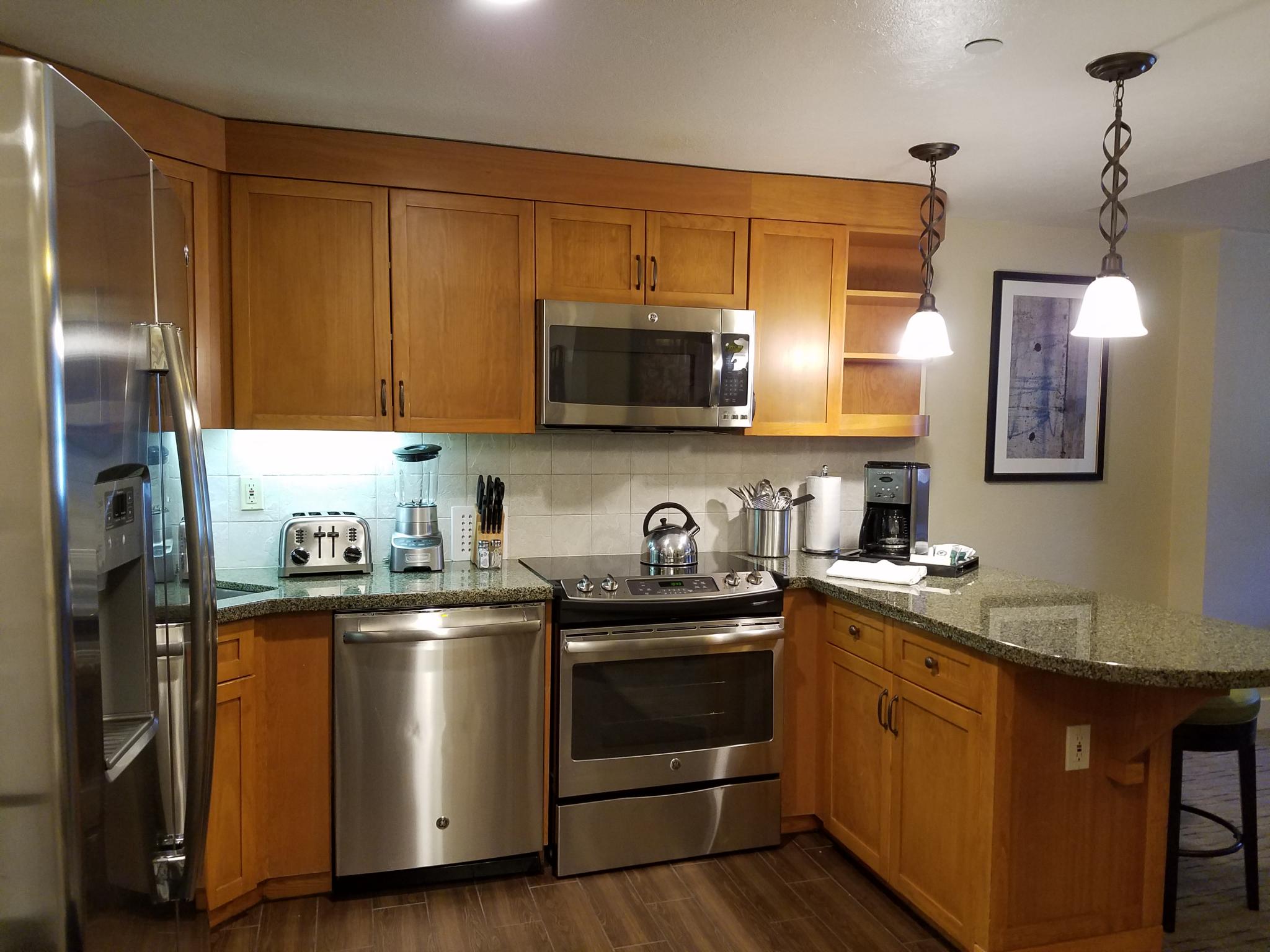 Fully equipped kitchen with granite counters and breakfast bar seating