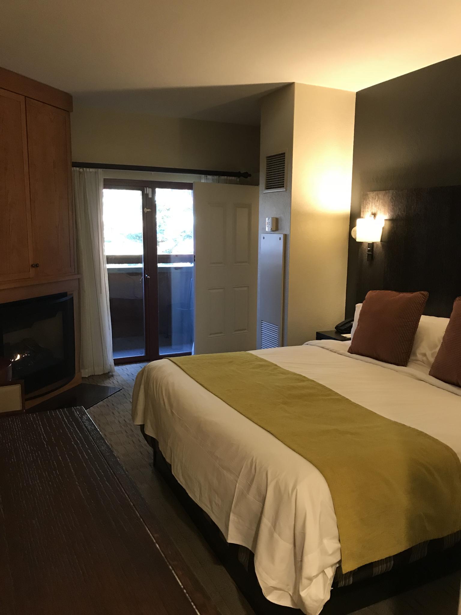 Cozy bedroom with fireplace and private balcony access