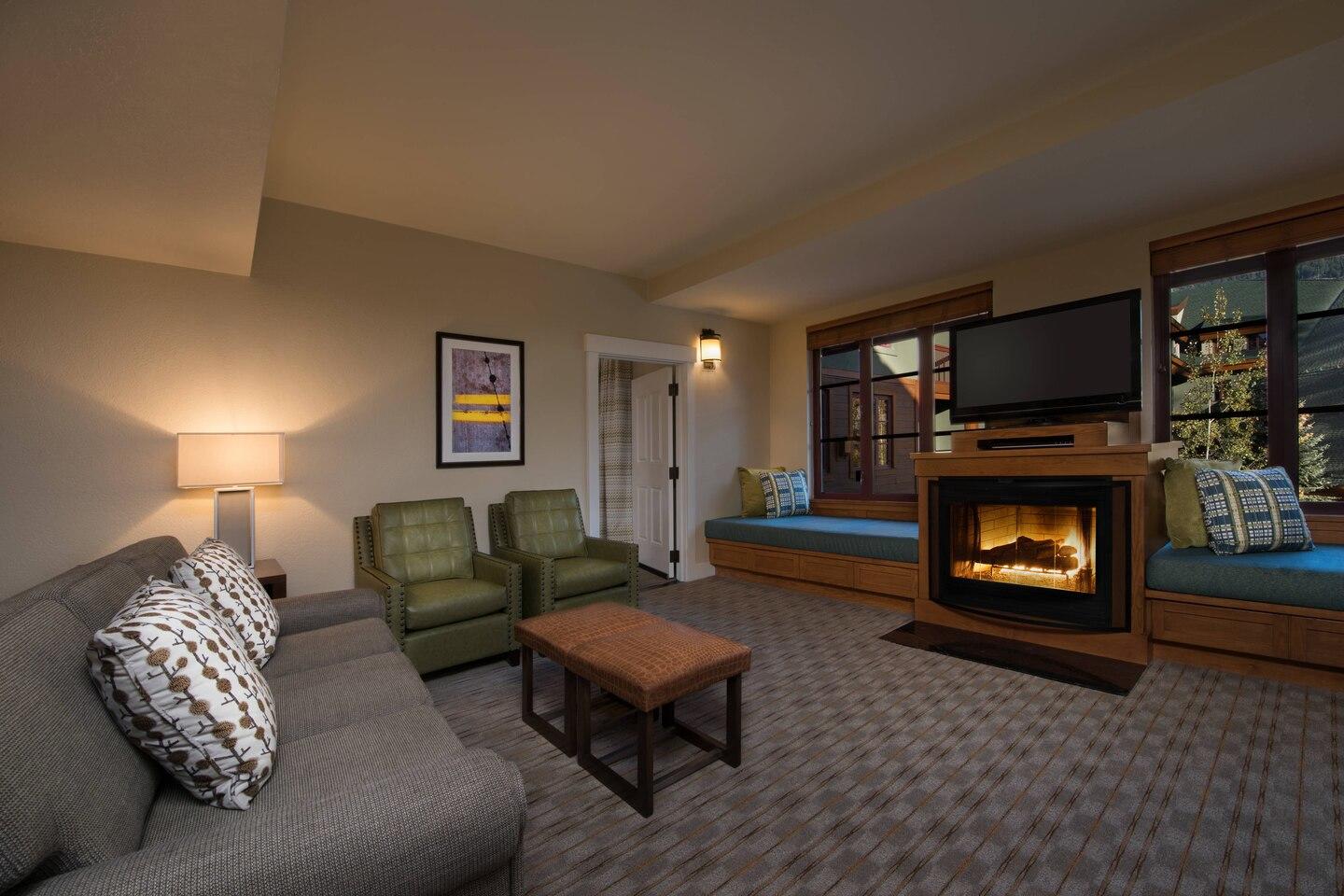 Cozy living room with fireplace, TV, and charming window bench seating