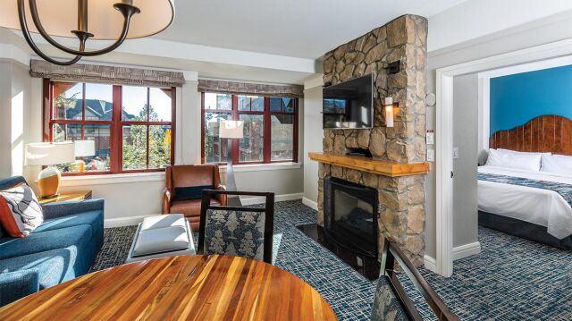 Bright mountain-style suite with stone fireplace and cozy living space