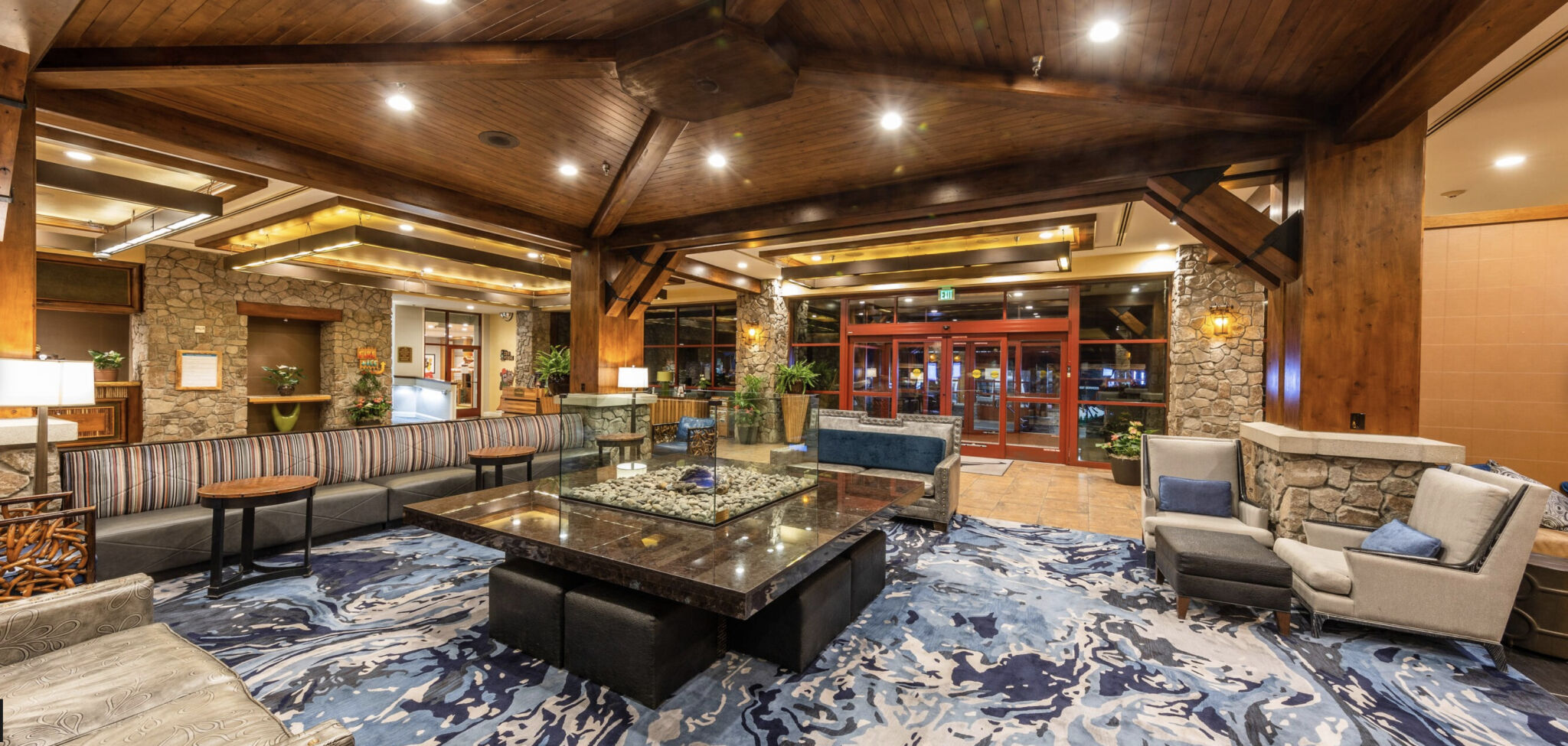 Warm, upscale lobby lounge with stone accents and inviting seating