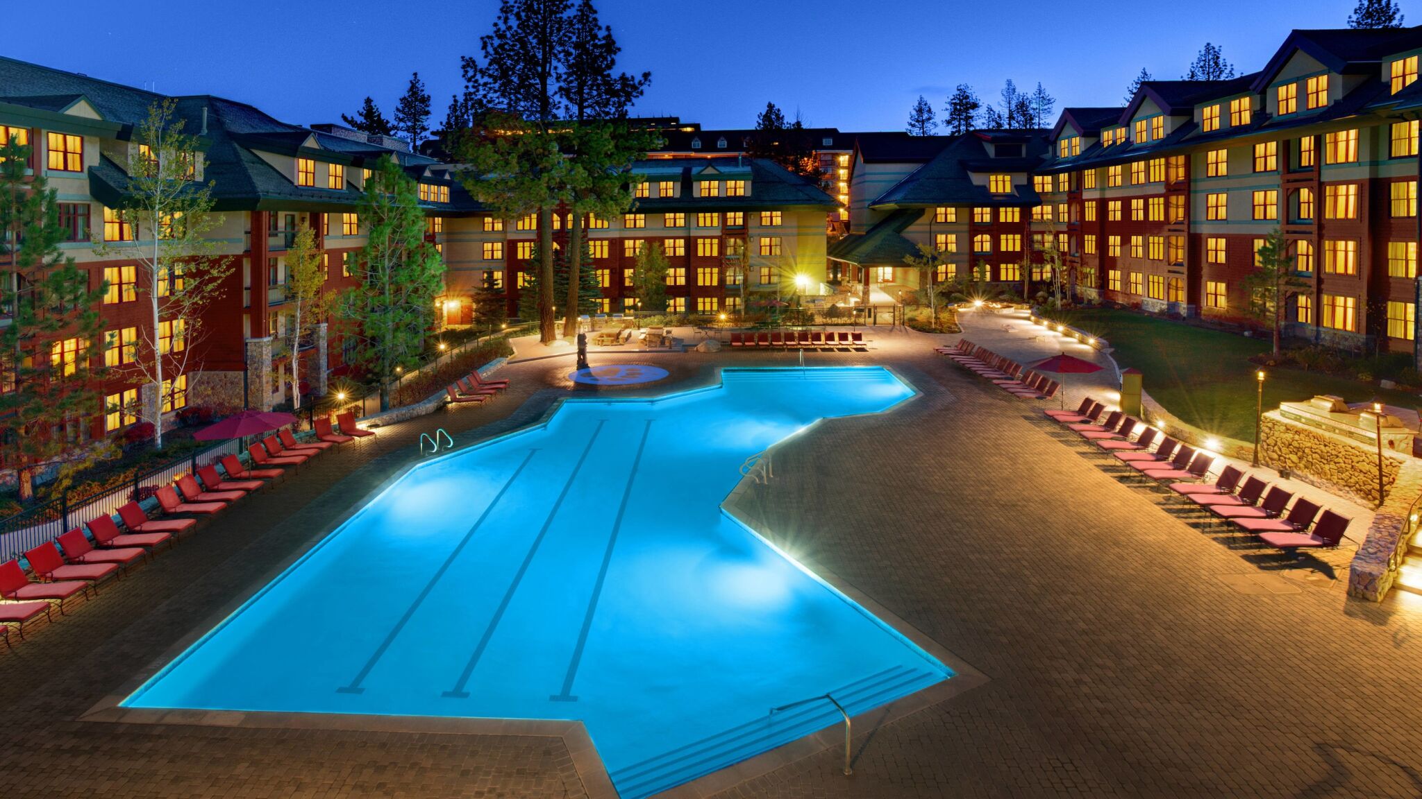 Resort-style heated pool courtyard with cozy mountain lodge ambiance