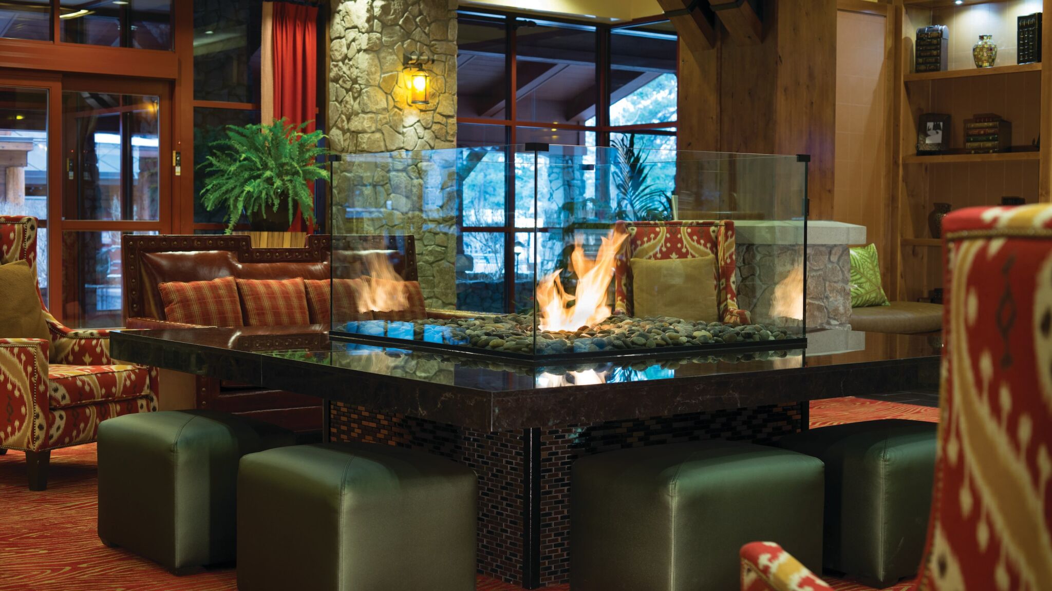 Cozy lodge-style lounge with a stunning glass fireplace centerpiece
