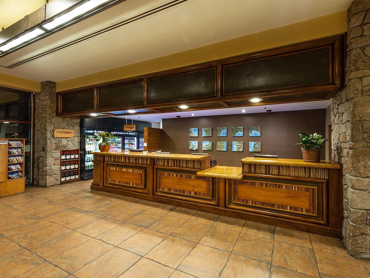 Warm lodge-style lobby with spacious front desk and guest snack area