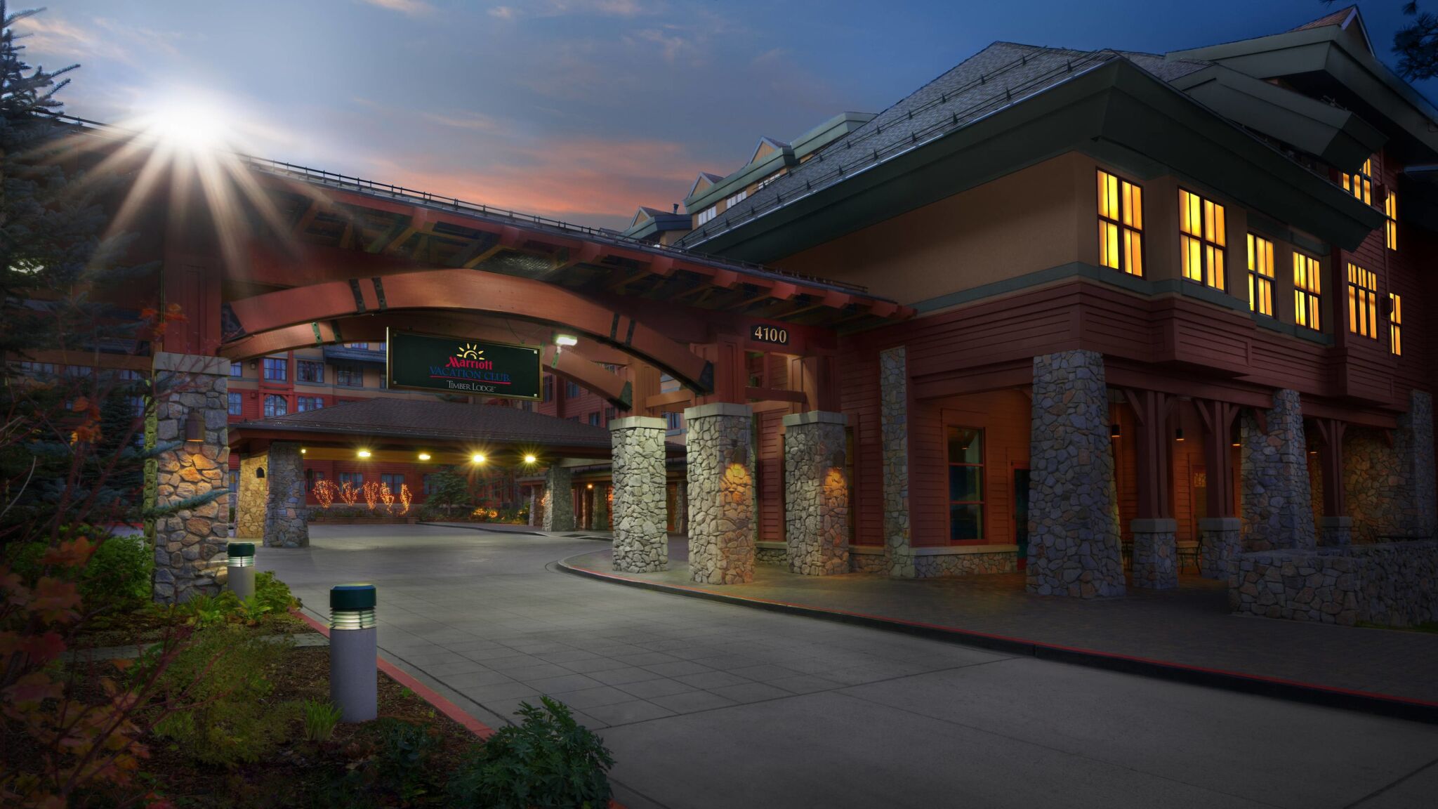 Grand lodge-style entrance with warm lighting and upscale mountain charm