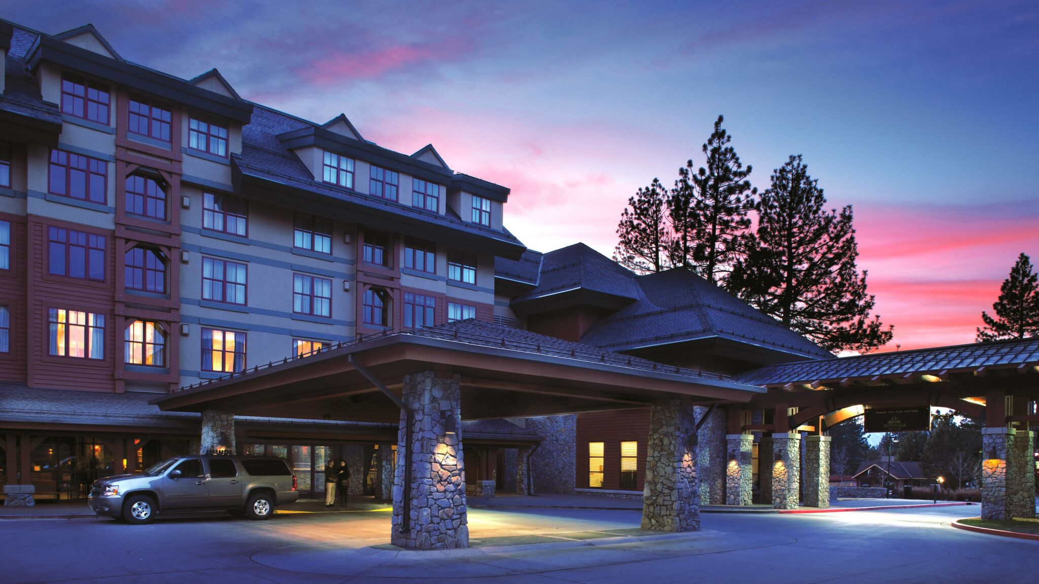 Welcoming lodge-style entrance with mountain charm at sunset