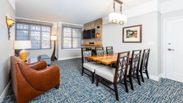 Bright living-dining space with seating for 6 and cozy stone fireplace