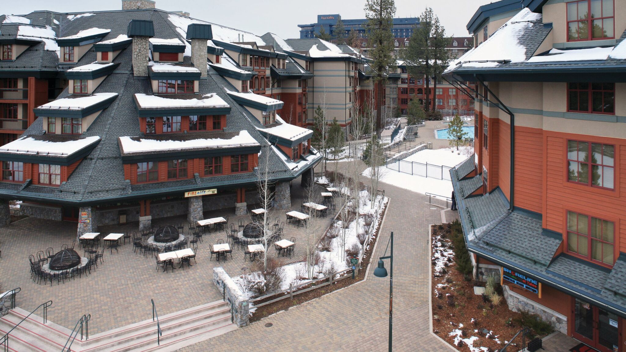 Snow-dusted mountain resort courtyard with cozy alpine village charm