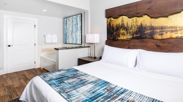 Bright modern bedroom with rustic artwork and convenient vanity area
