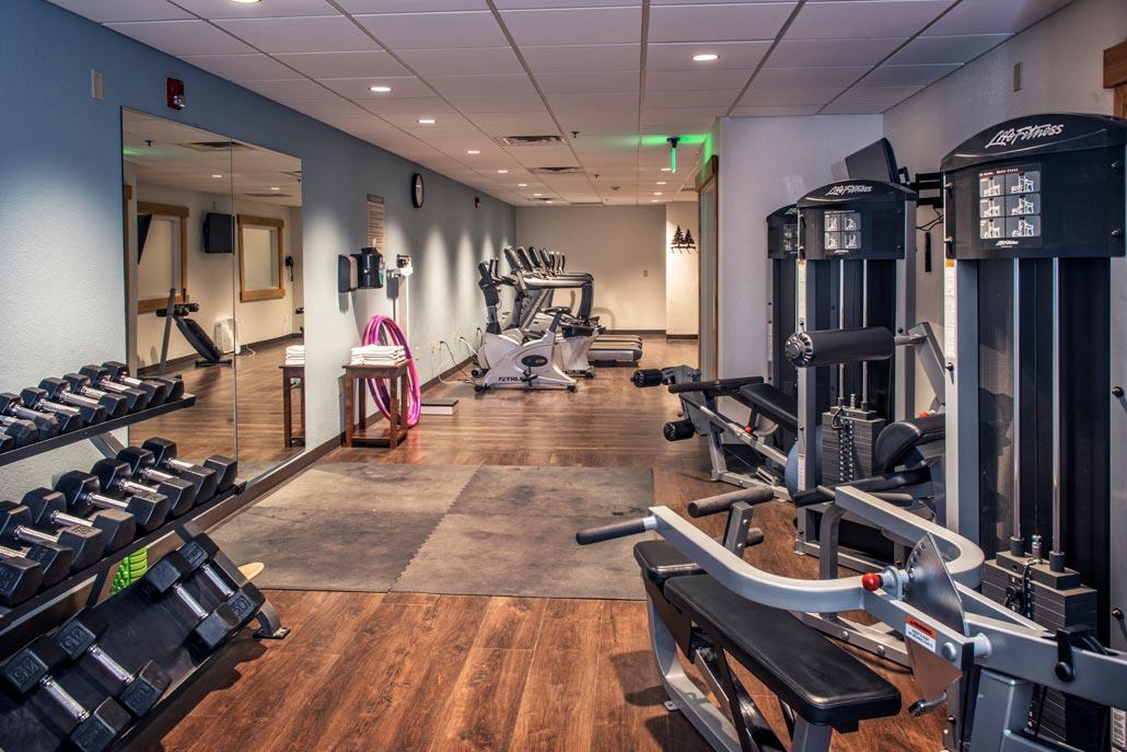 Well-equipped fitness room with cardio, weights, and space to stretch