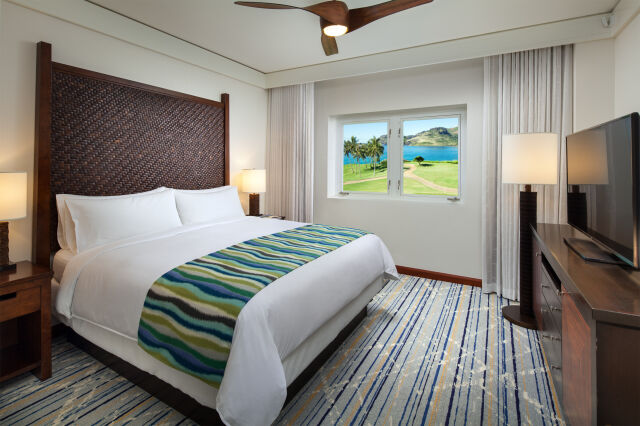 Bright island-style king room with ocean views and resort-inspired comfort