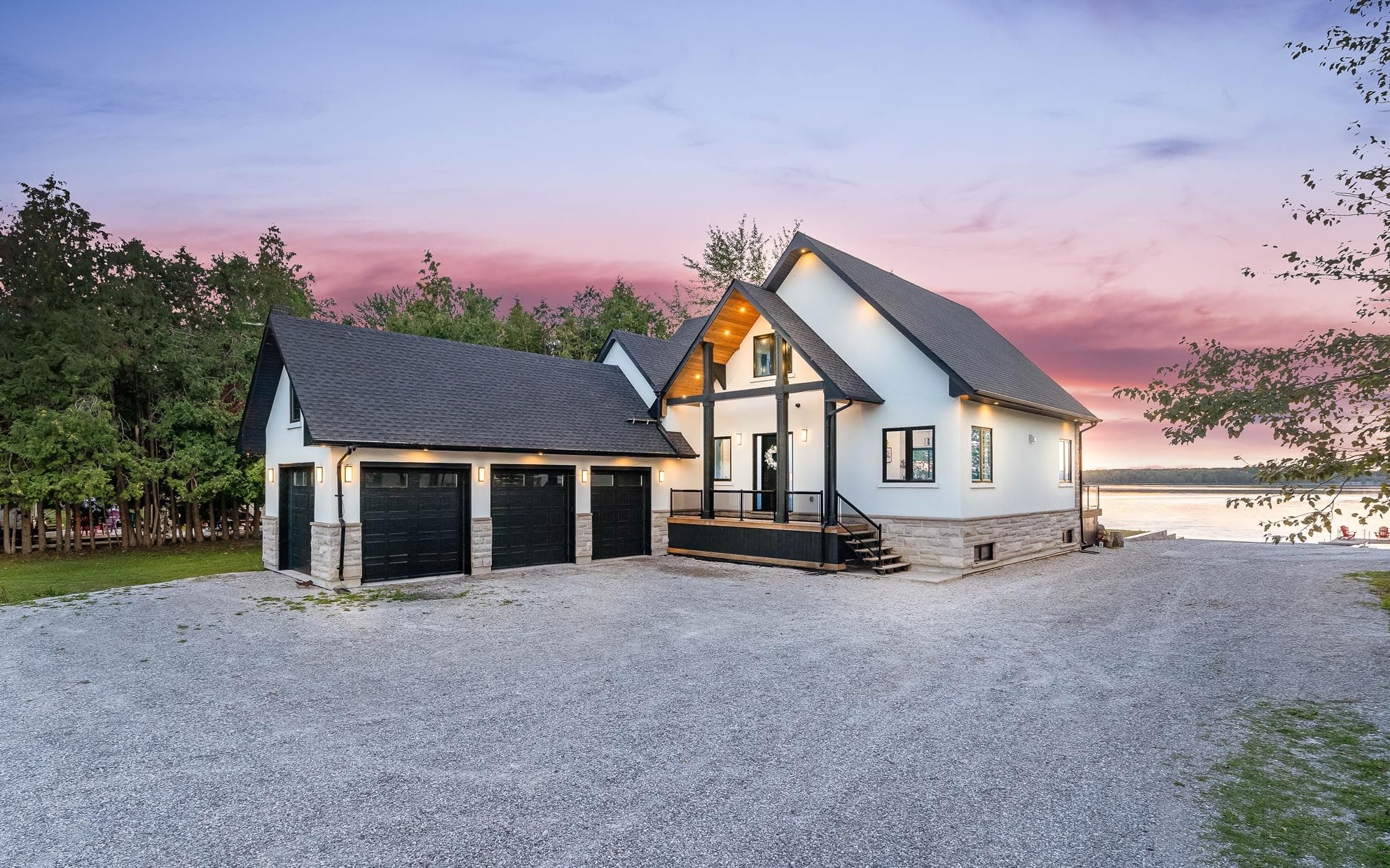 Newly built Blue Bird Lakehouse on Lake St. John in Orillia at dusk