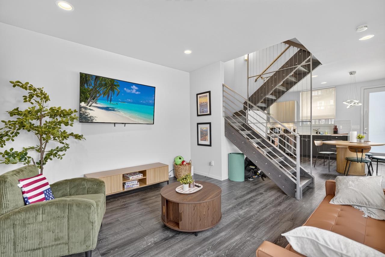 Bright modern living space with designer staircase and open kitchen