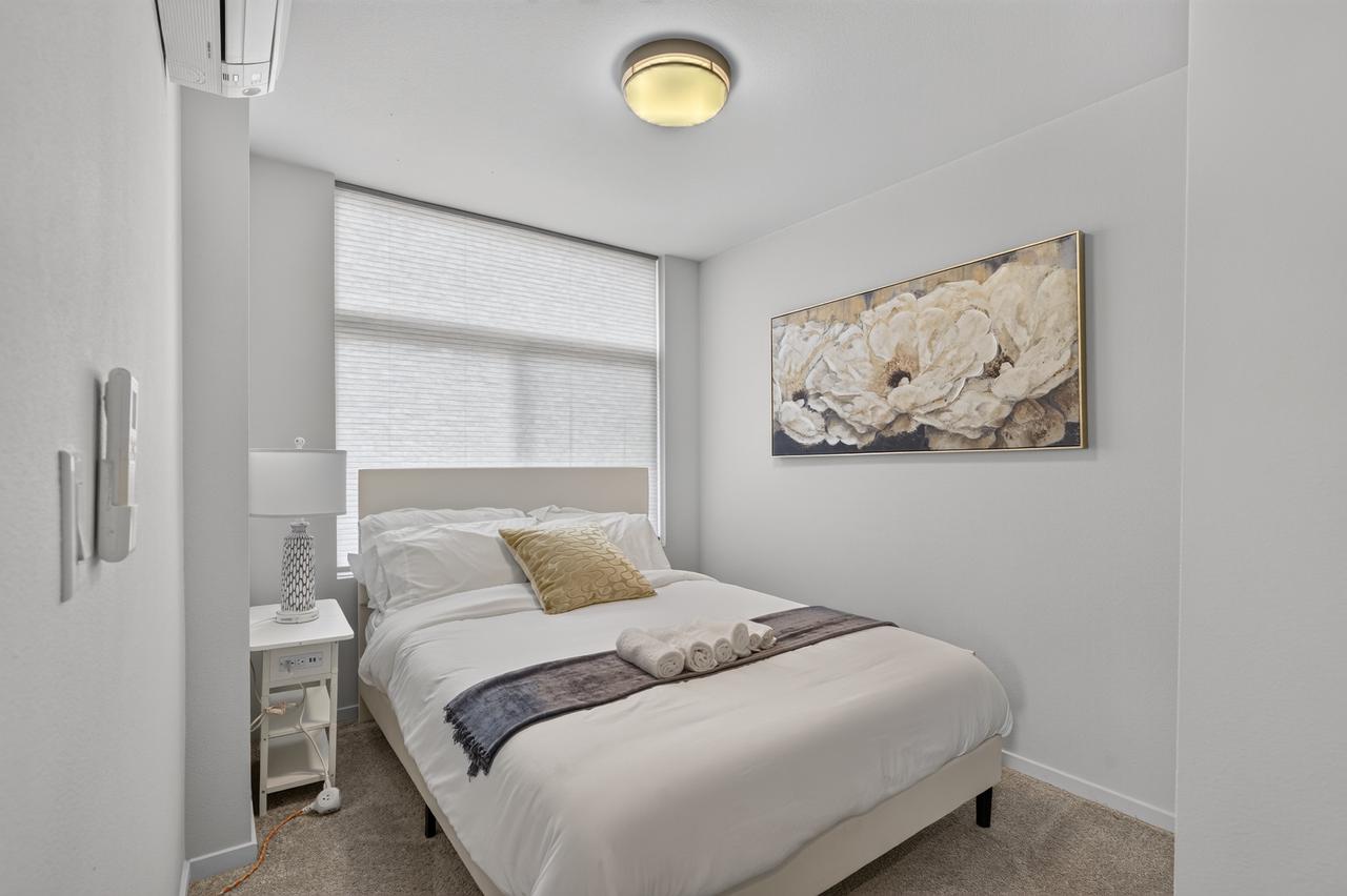 Bright, cozy bedroom with natural light and crisp modern styling