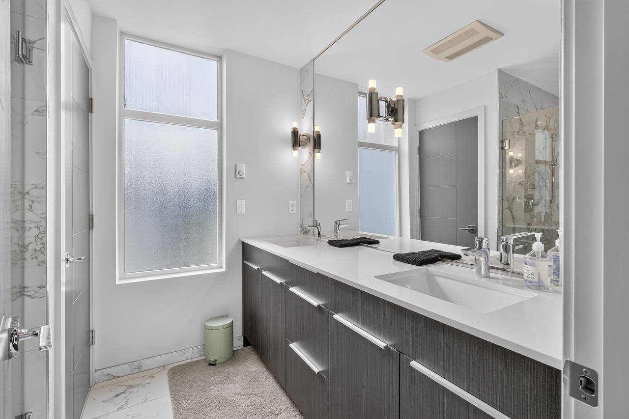 Bright spa-style bathroom with double vanity and natural light