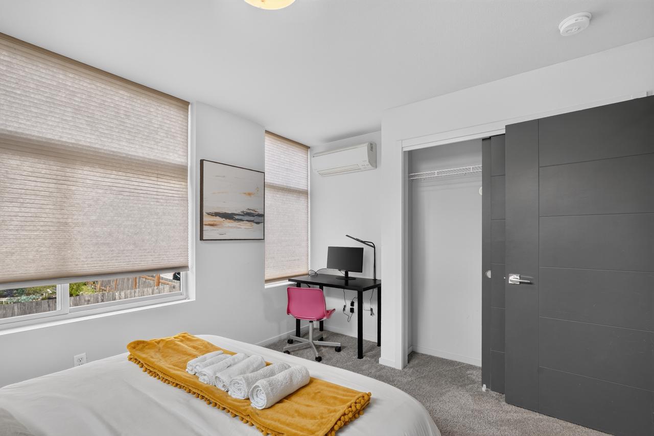 Bright bedroom with workspace, AC, and large windows