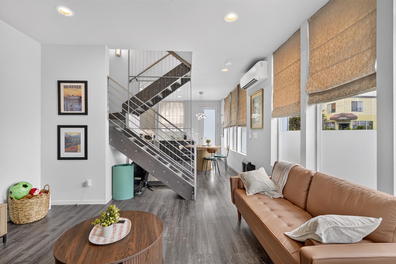 Bright modern living room with designer staircase and sun-filled windows