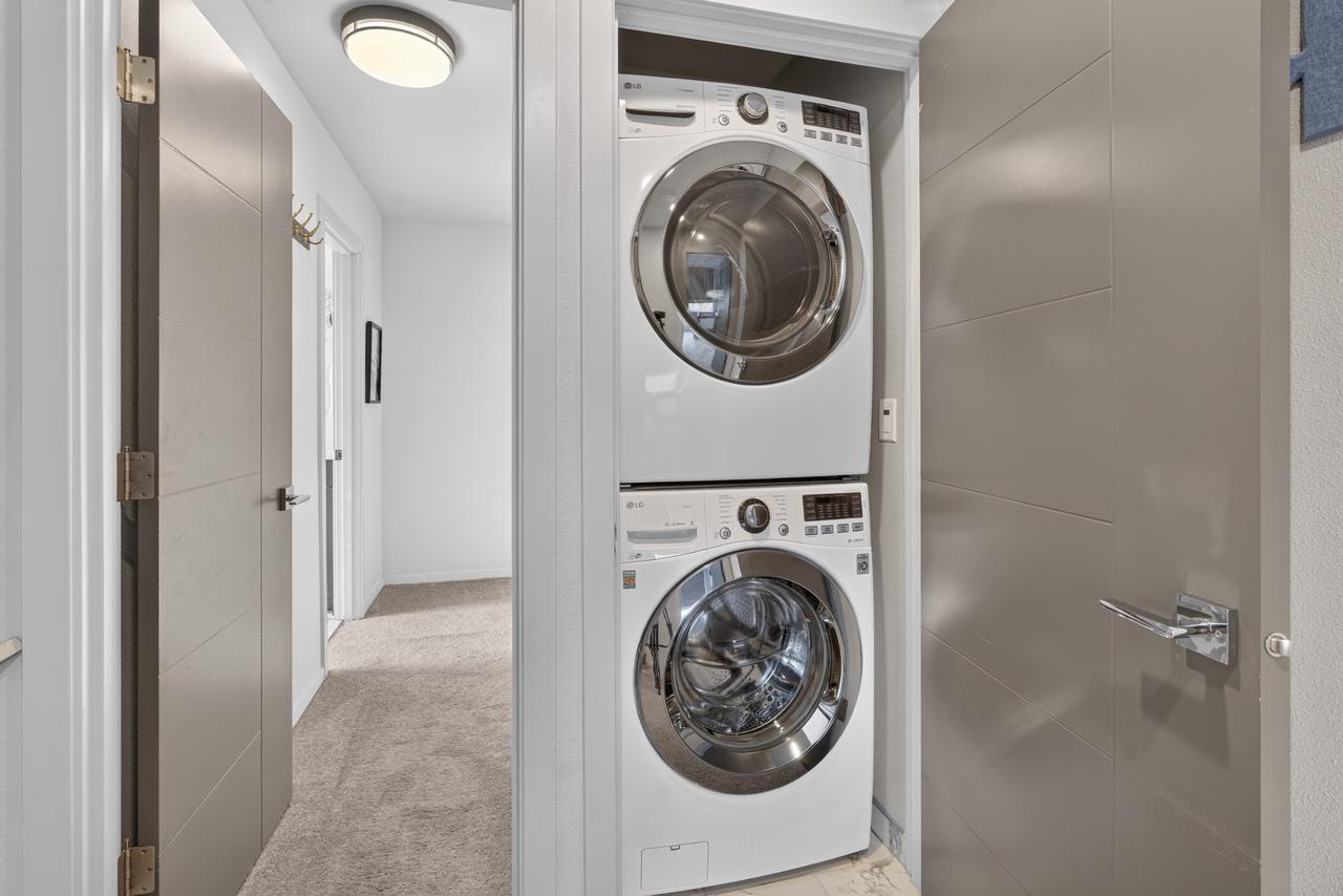 Convenient in-unit washer/dryer tucked into a bright modern hallway