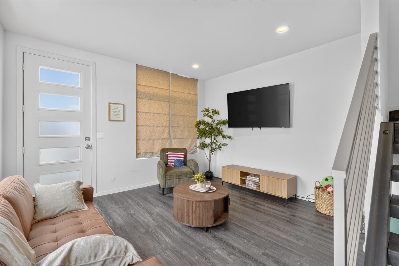 Bright modern living room with wall-mounted TV and stylish seating