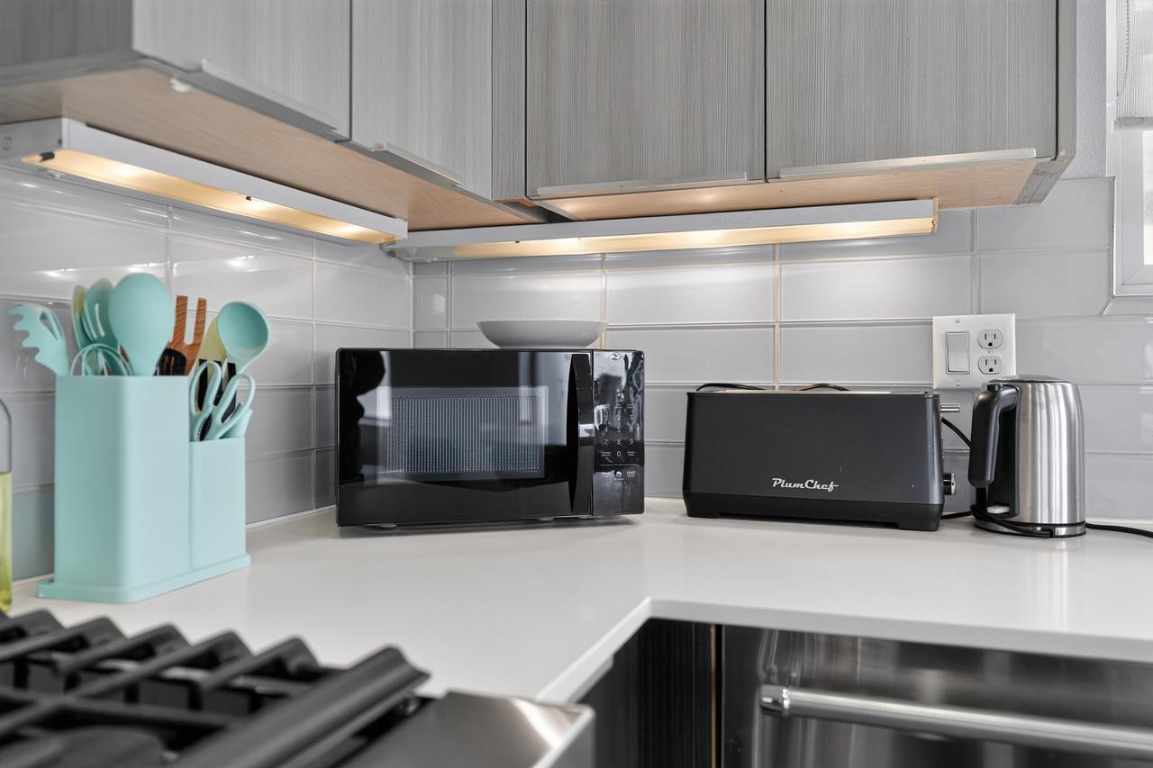 Modern kitchen setup with bright counters and handy small appliances