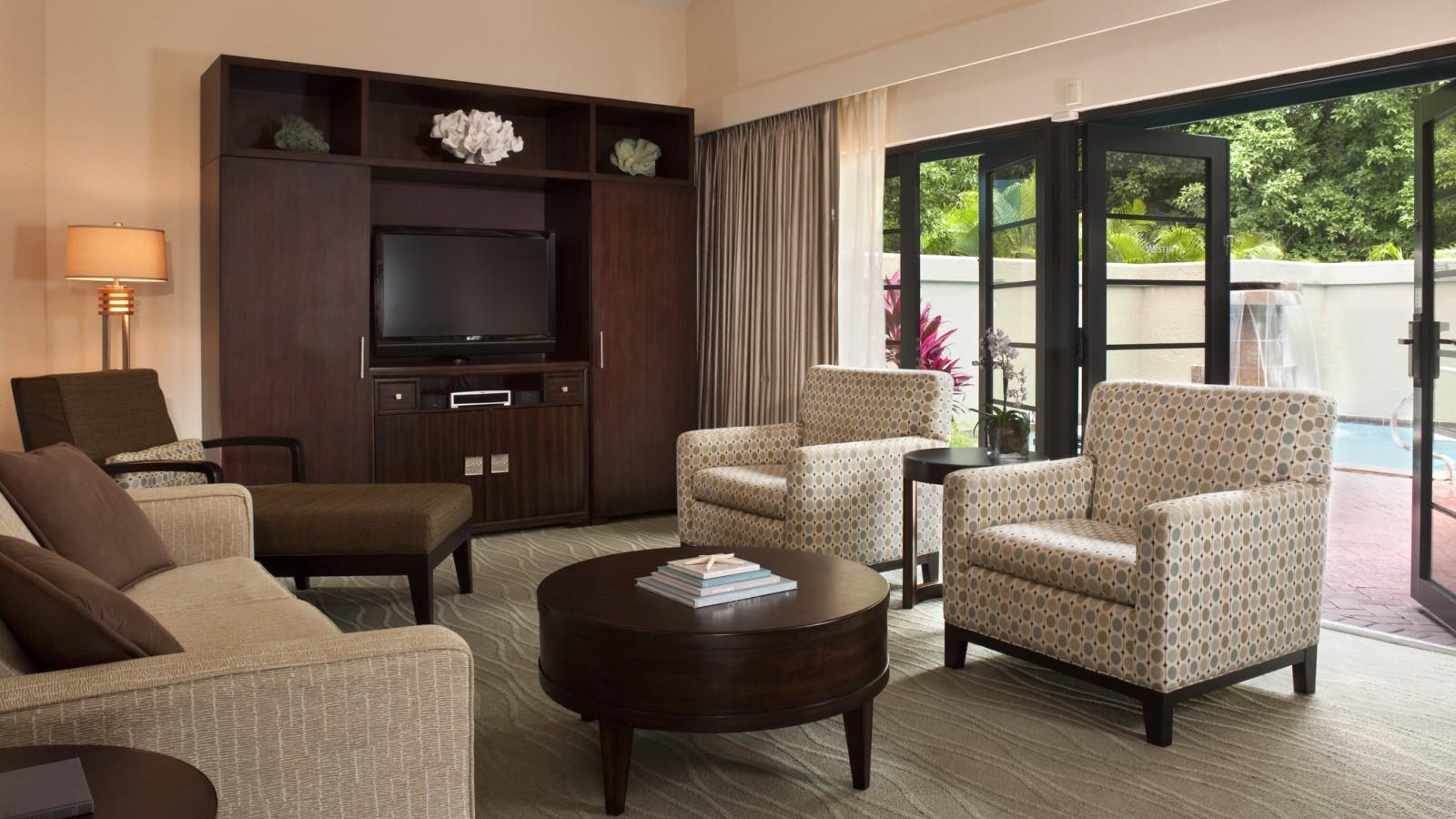 Bright, spacious lounge with poolside patio access