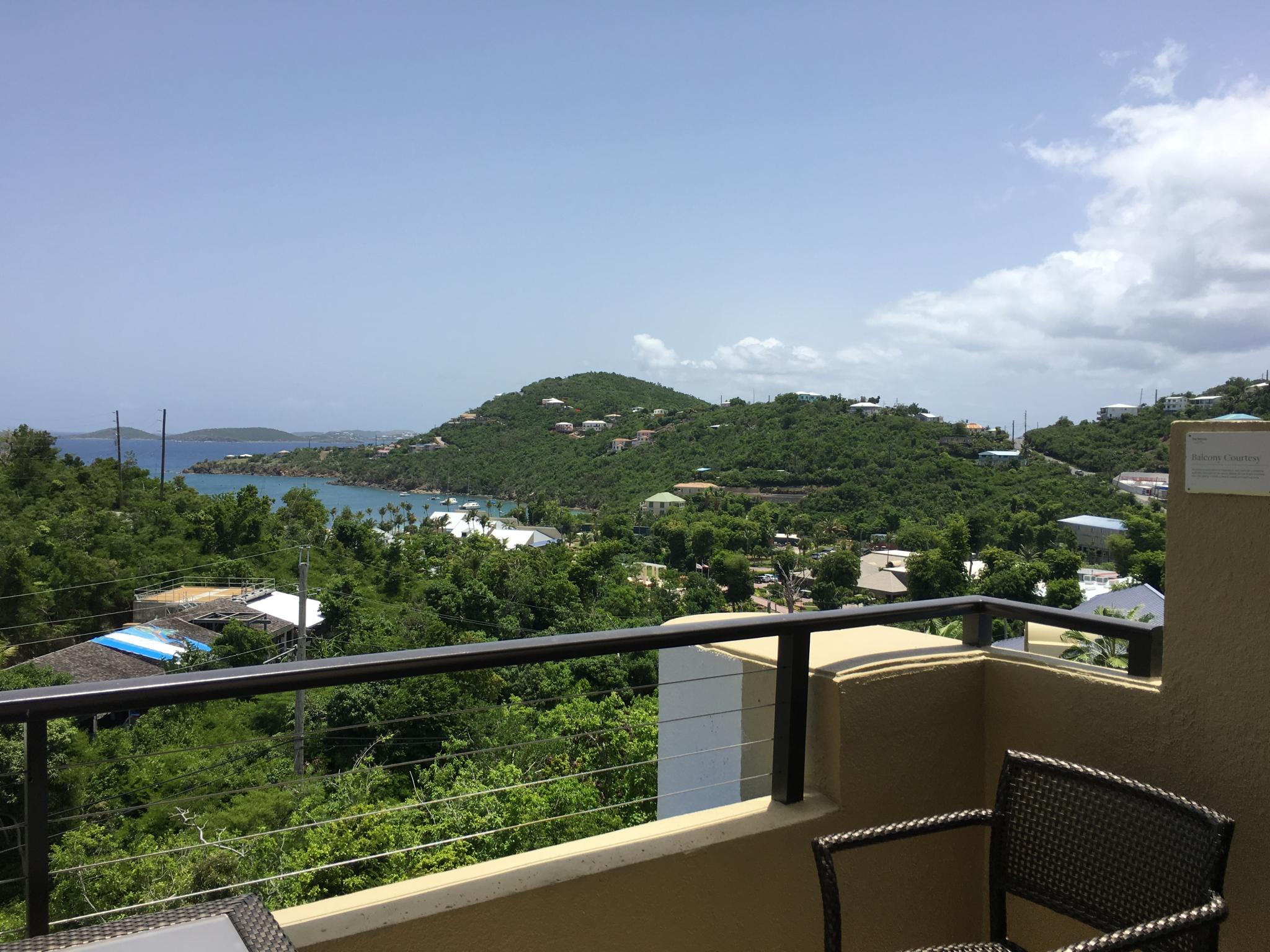 Private balcony with sweeping hilltop and turquoise bay views