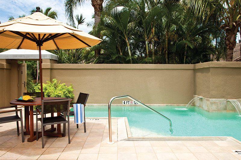 Private tropical plunge pool with shaded patio dining