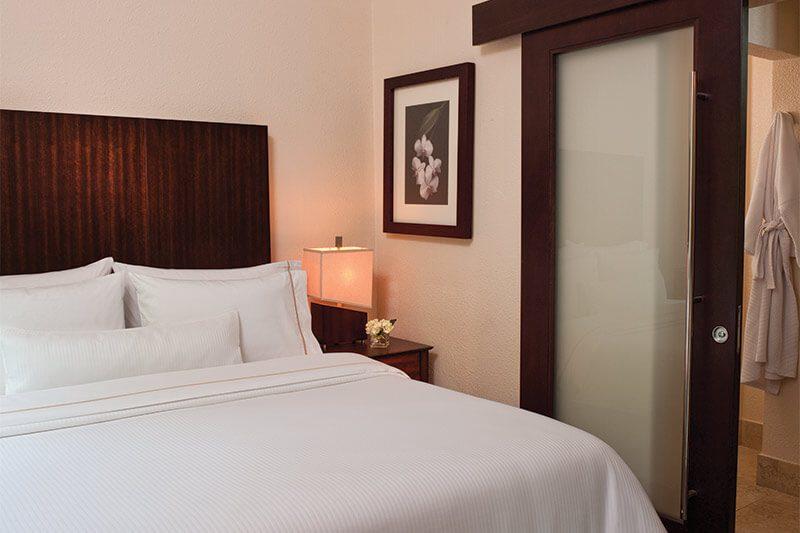 Cozy bedroom with plush linens and convenient ensuite-style bath access