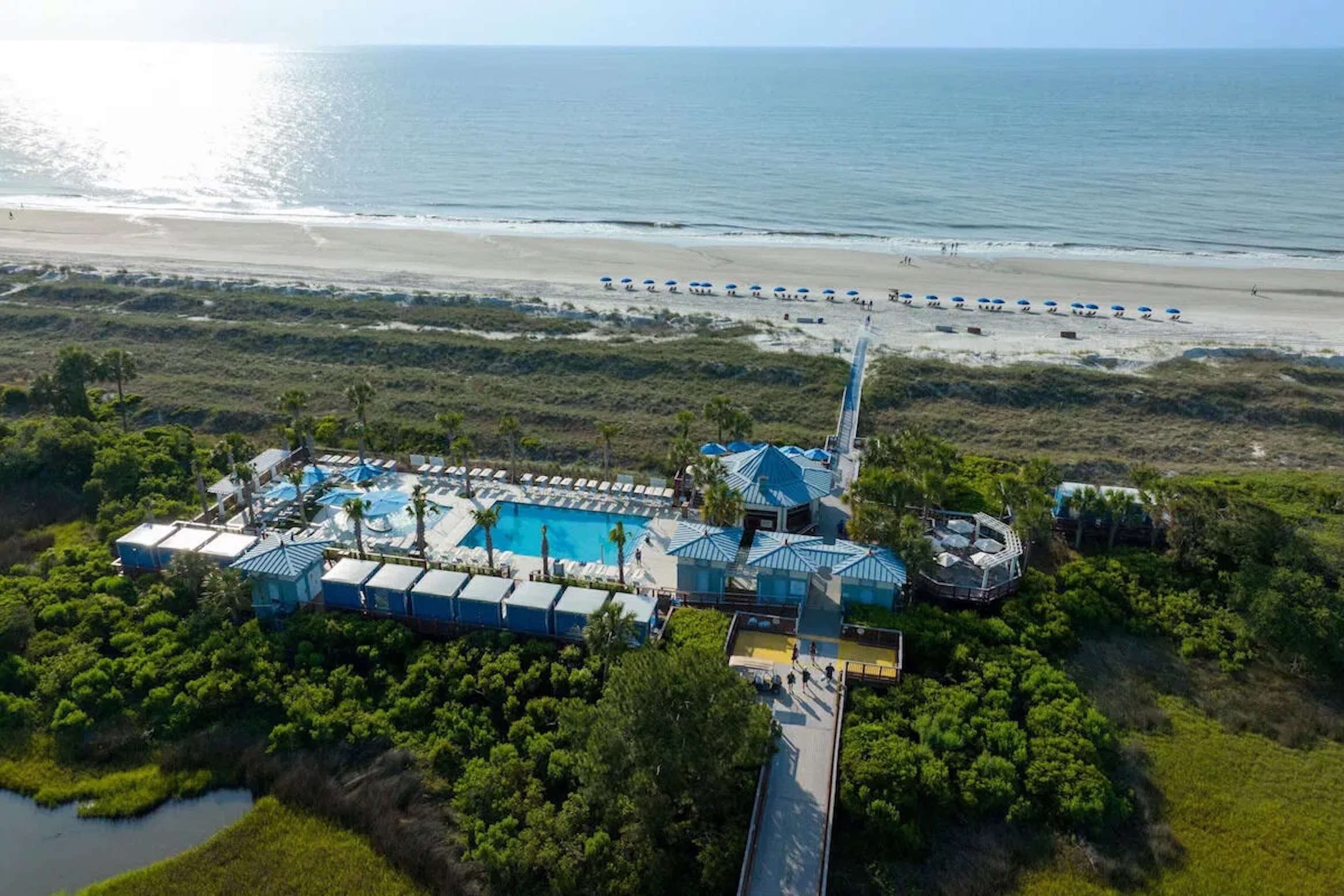 Oceanfront pool oasis with private beach boardwalk and sweeping coastal views